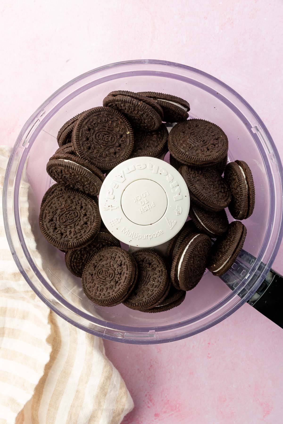 A food processor with gluten-free Oreos in it before processing.