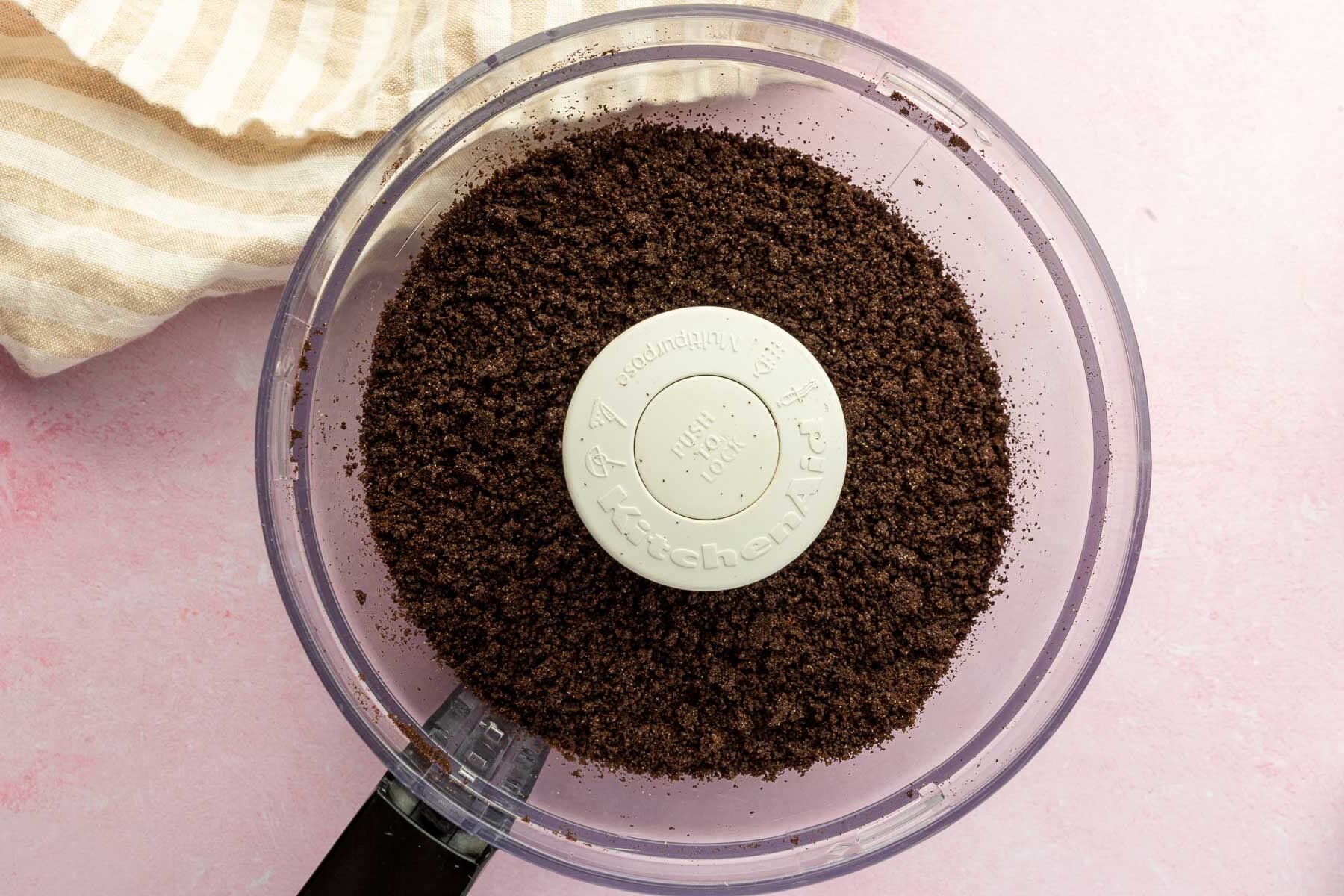 A food processor with gluten-free Oreos that have been pulsed into fine crumbs.