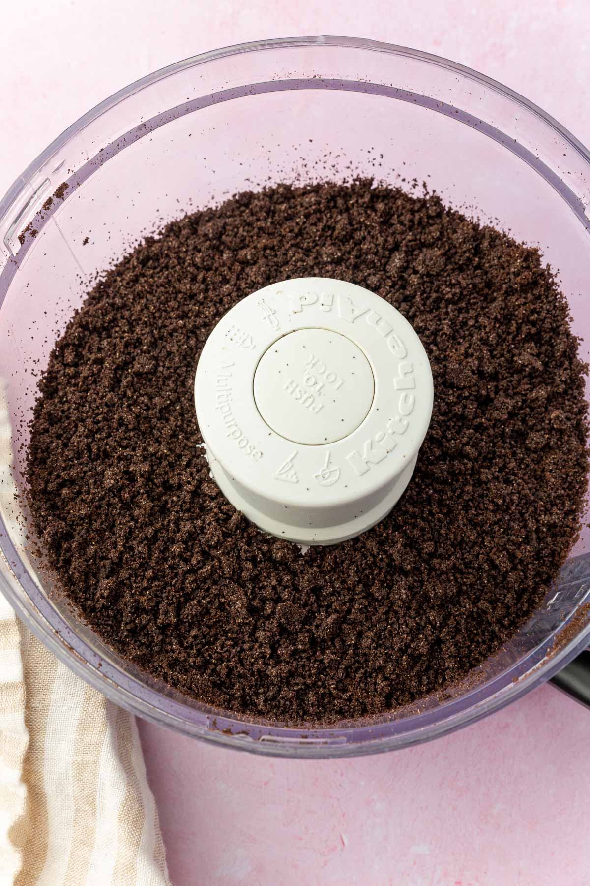 A food processor with gluten-free Oreos that have been pulsed into fine crumbs.