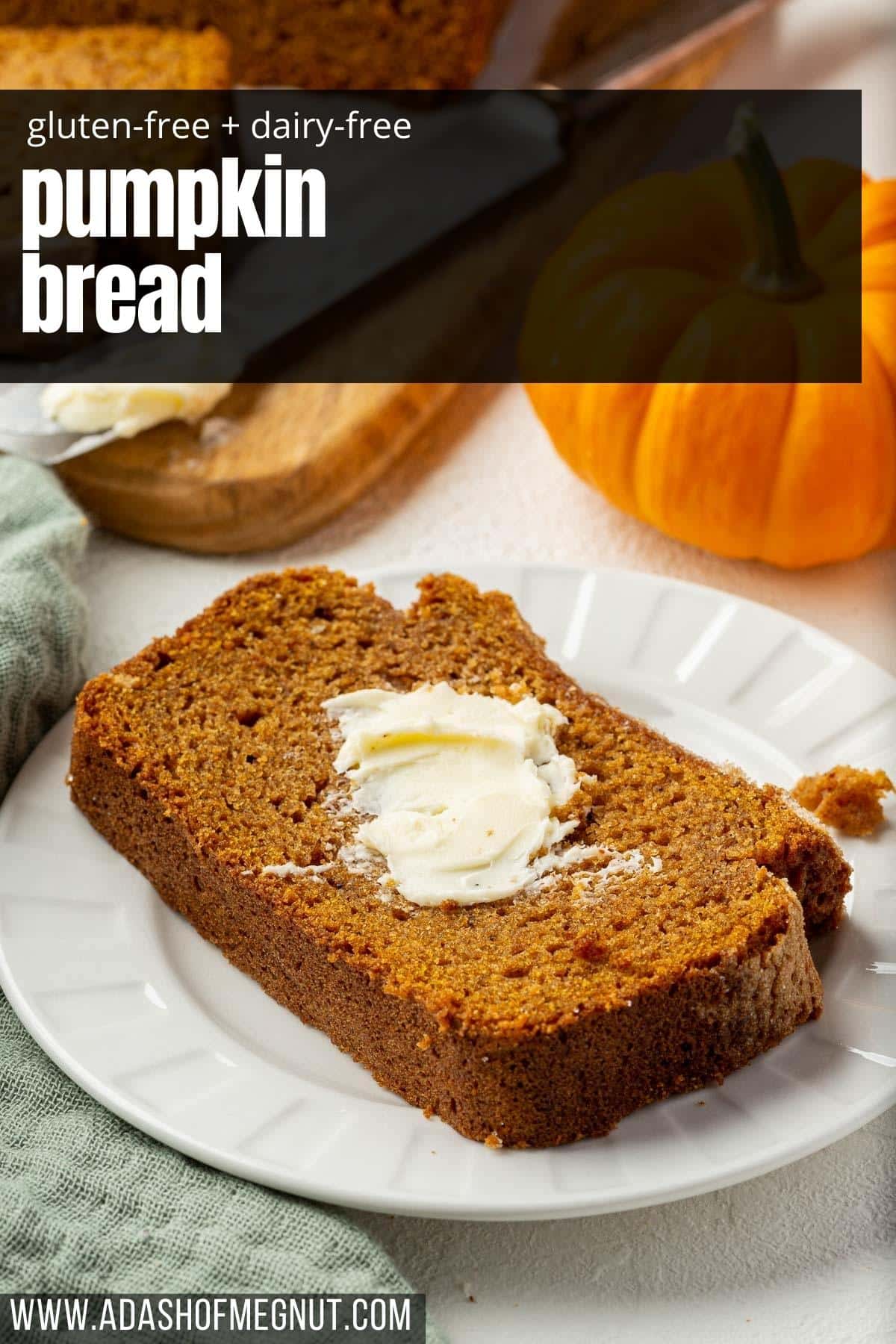A single slice of gf pumpkin bread on a dessert plate and slathered with butter.