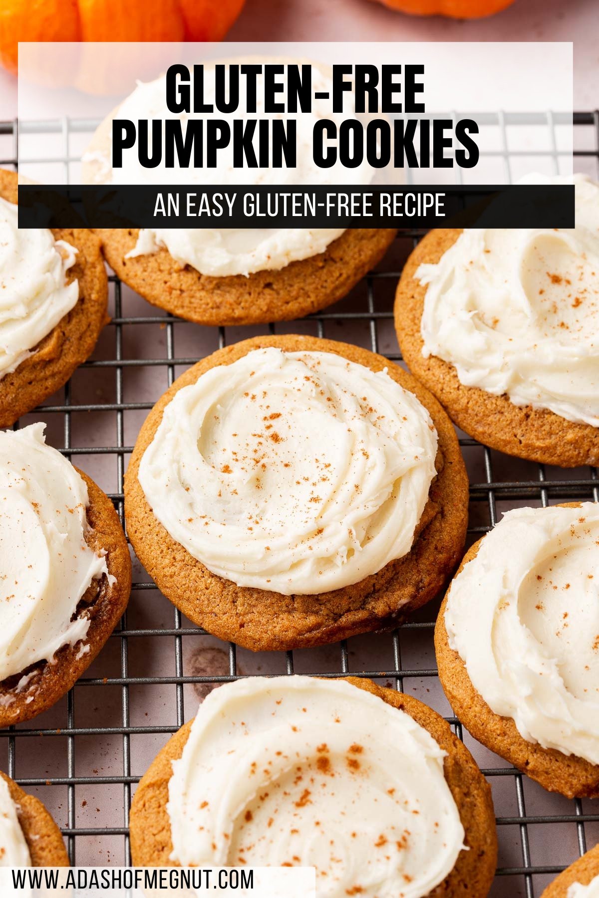 A dozen gluten free pumpkin cookies with cream cheese frosting on a wire rack.