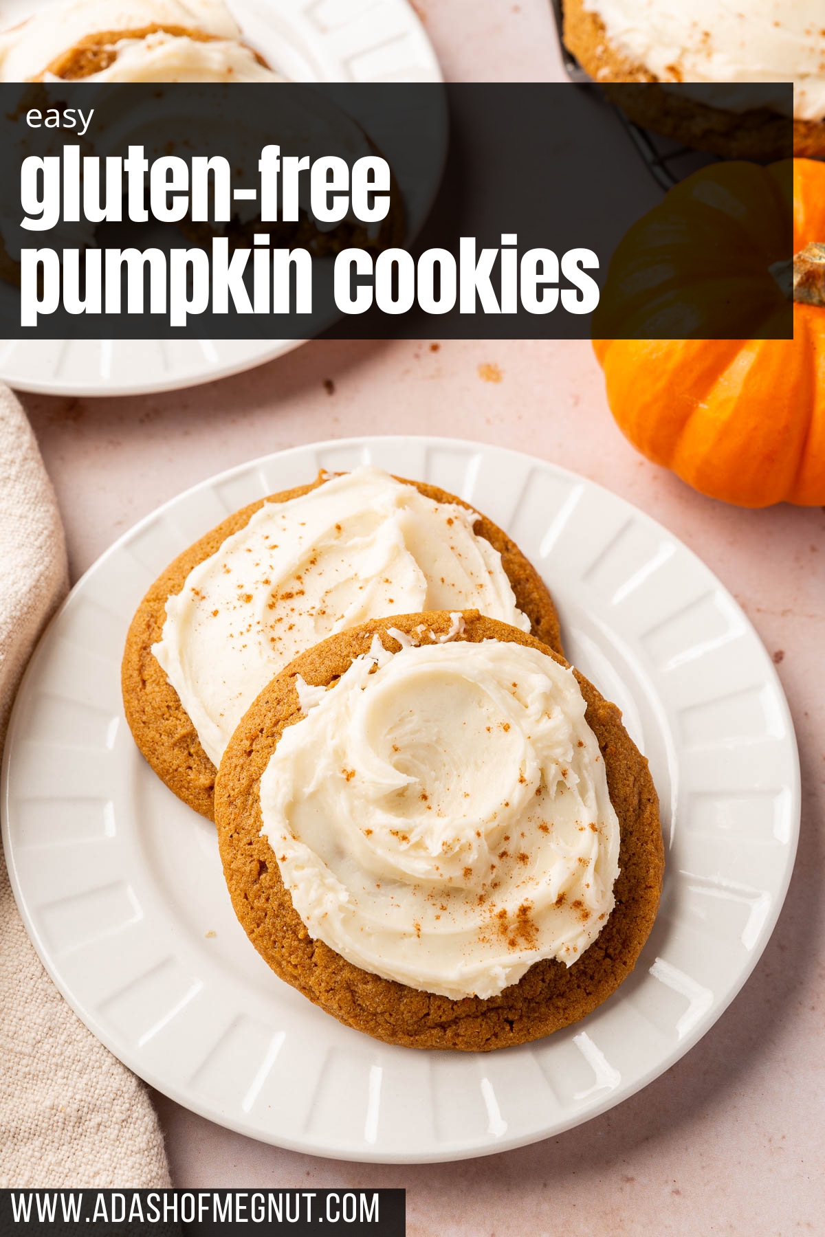 Two gluten free pumpkin cookies with cream cheese frosting swirls on a dessert plate.