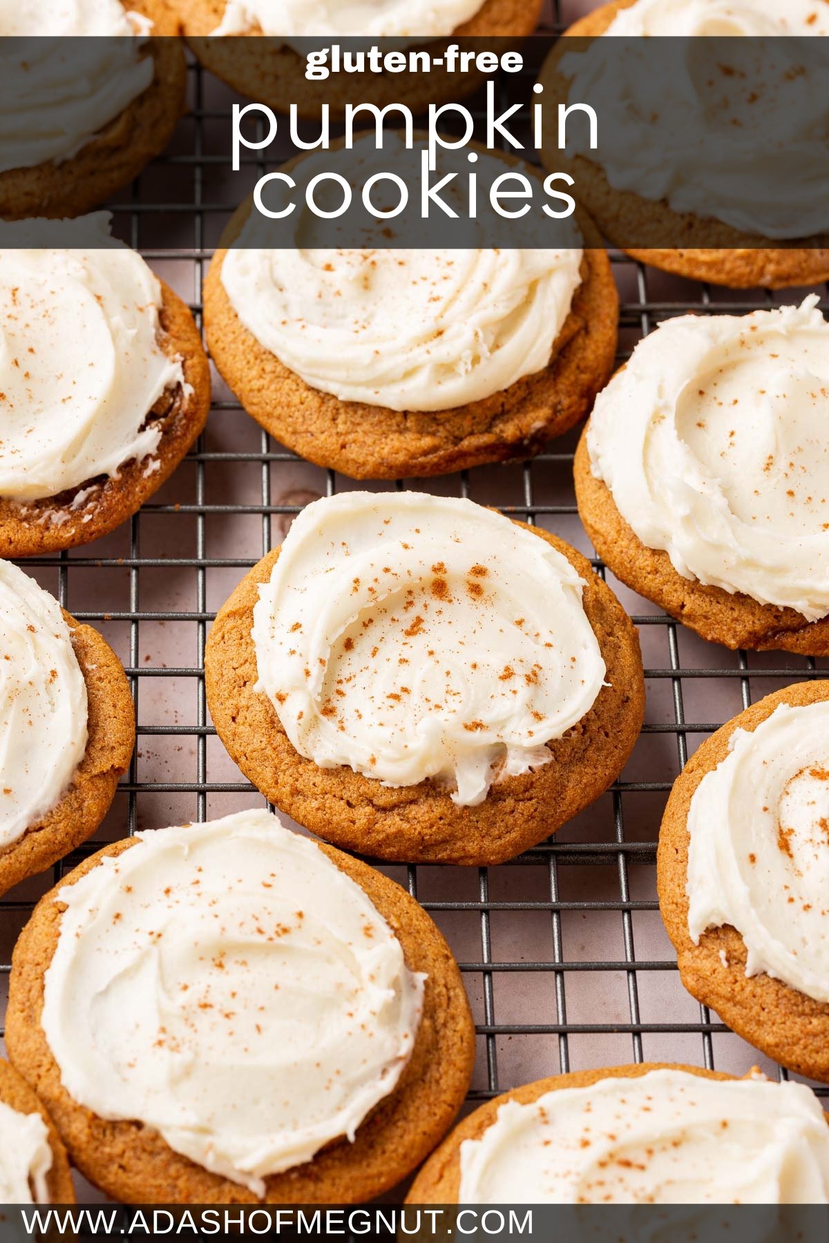 A dozen gluten free pumpkin cookies with cream cheese frosting on a wire rack.