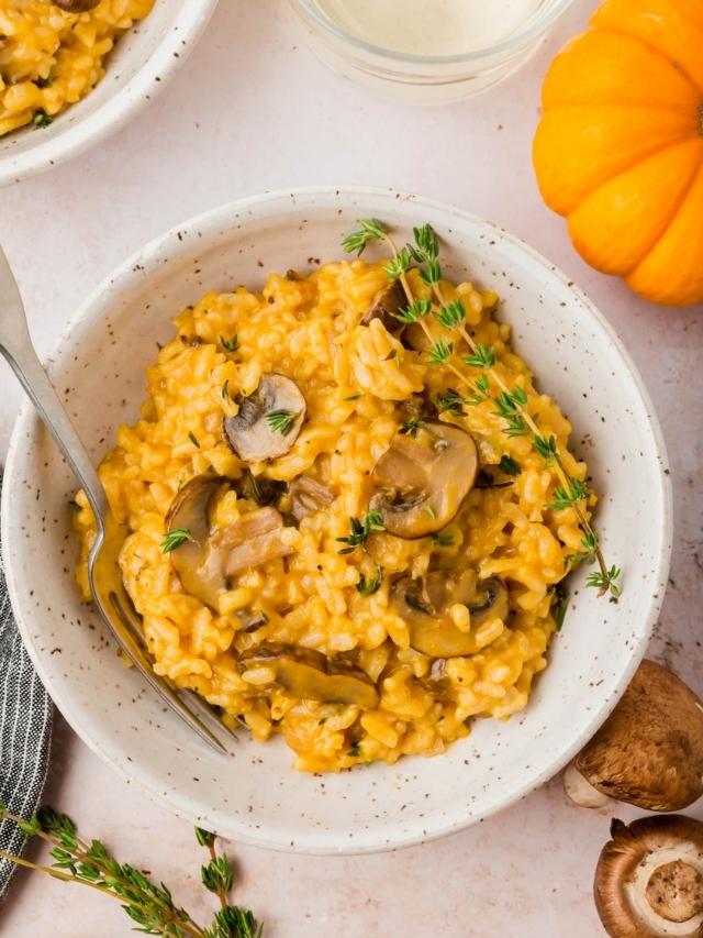 A bowl of instant pot pumpkin mushroom risotto with a mini pumpkin next to it.