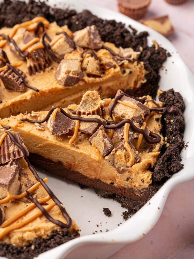 Slices of gluten-free Oreo peanut butter pie topped with reese's peanut butter cups in a pie plate.