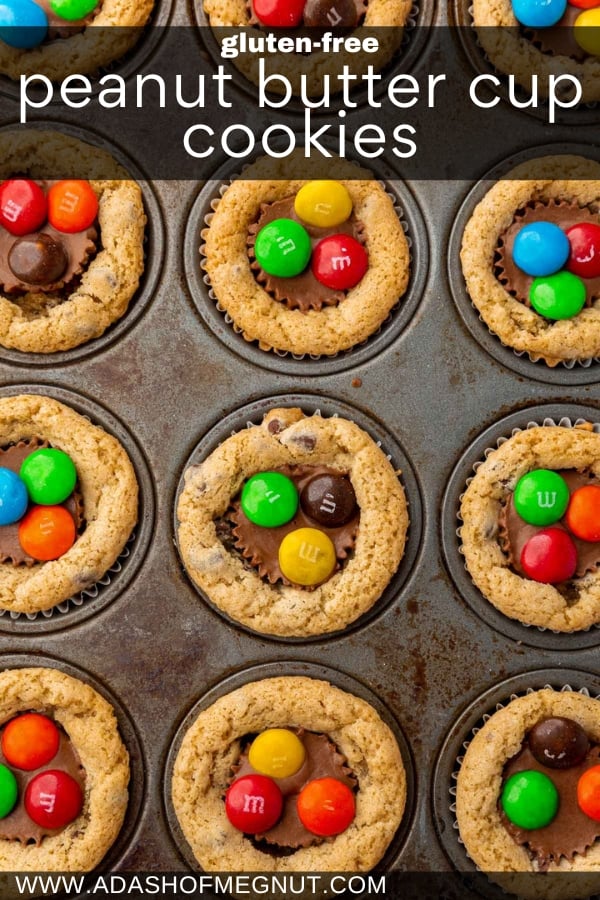 An overhead view of a mini muffin pan filed with chocolate chip cookie cups with mini peanut butter cups and M&Ms inserted in the center.