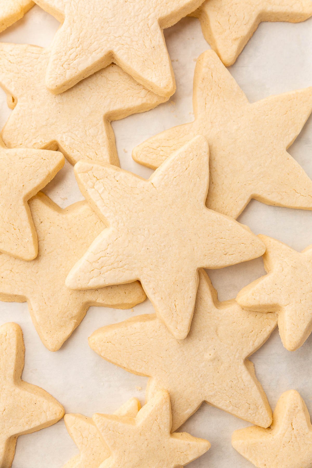 Gluten-free sugar cookies cut into the shape of stars stacked on top of one another.