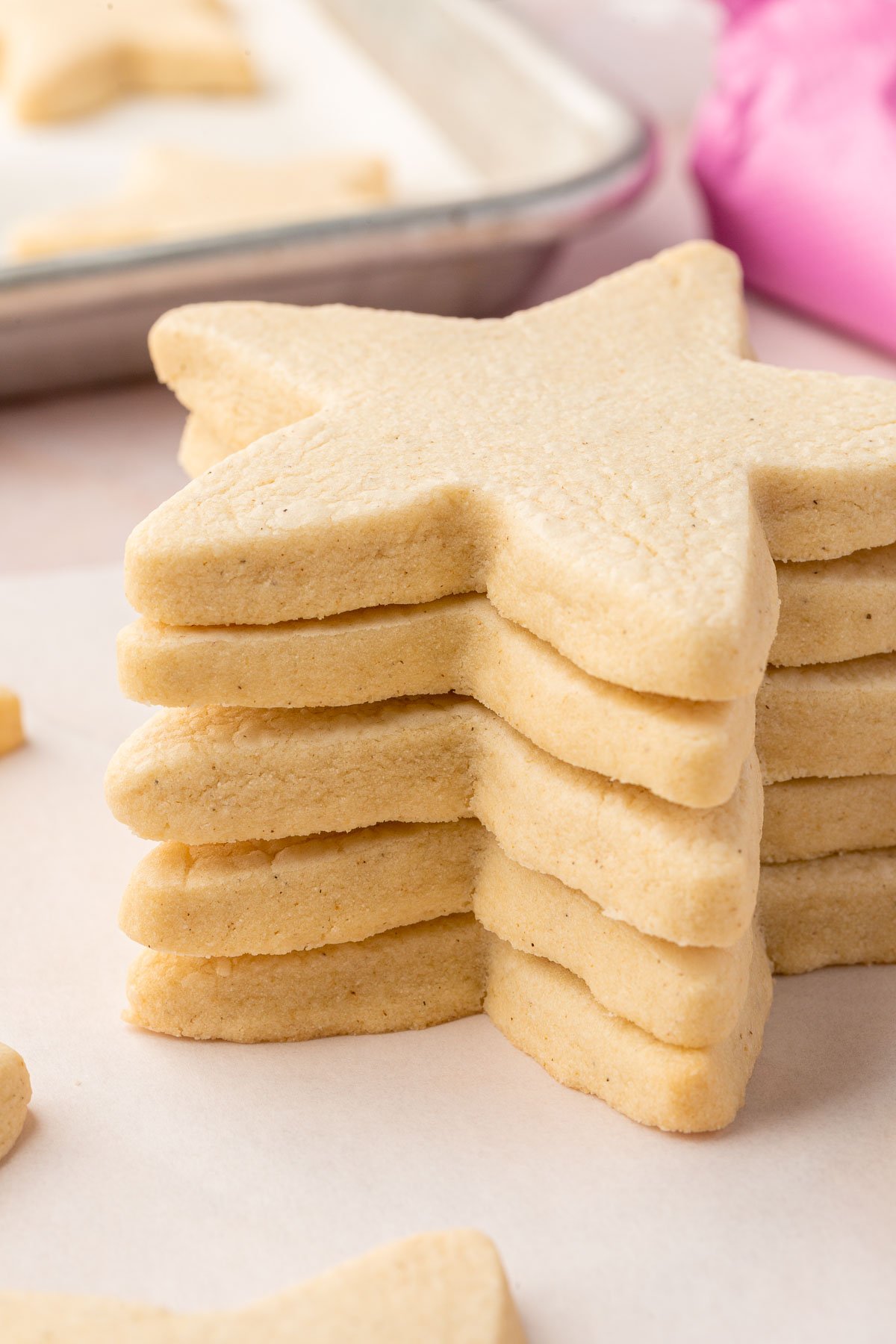 Five gluten-free cut out sugar cookies shaped as stars stacked on top of one another.