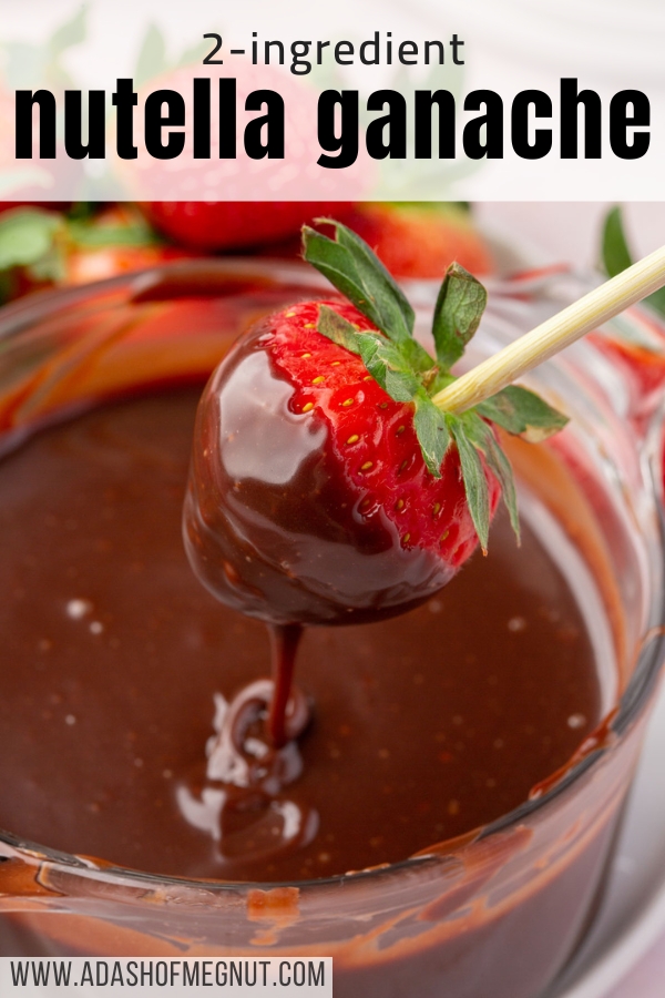 A strawberry on a wooden skewer that has been dipped into Nutella ganache over a bowl of more ganache.