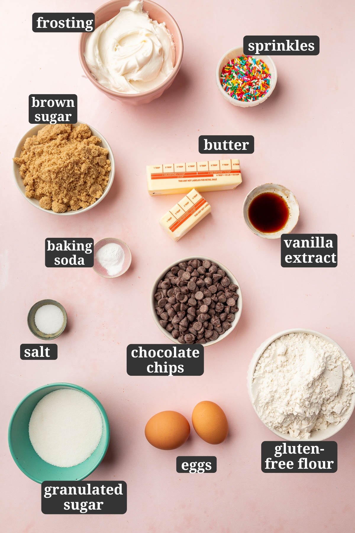 Ingredients in small bowls to make gluten-free cookie cups, including vanilla frosting, rainbow sprinkles, brown sugar, unsalted butter, vanilla extract, baking soda, salt, chocolate chips, gluten-free flour, two eggs, and granulated sugar with text overlays over each ingredient.