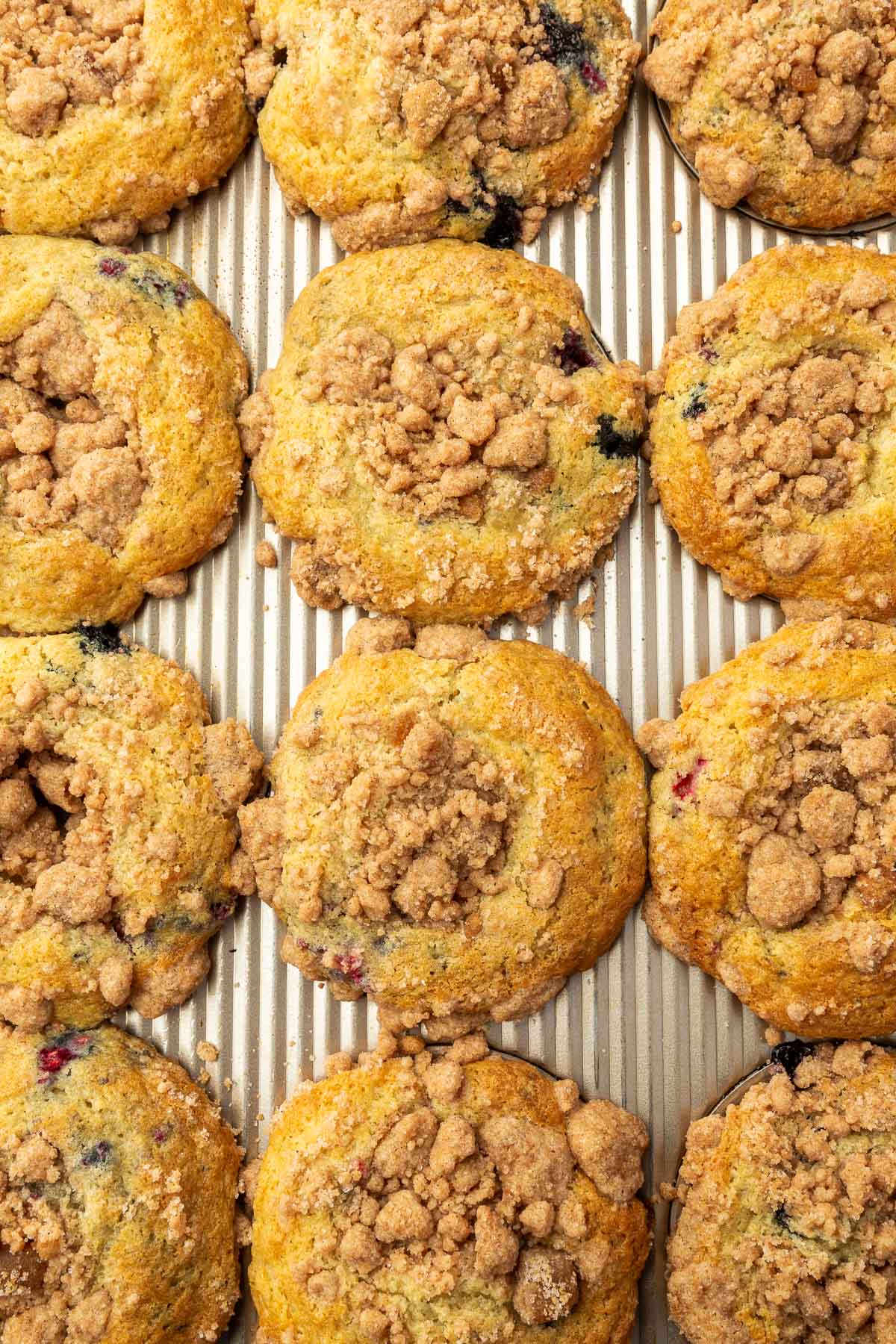 An overhead view of 12 gluten-free muffins with streusel baked in a muffin pan.