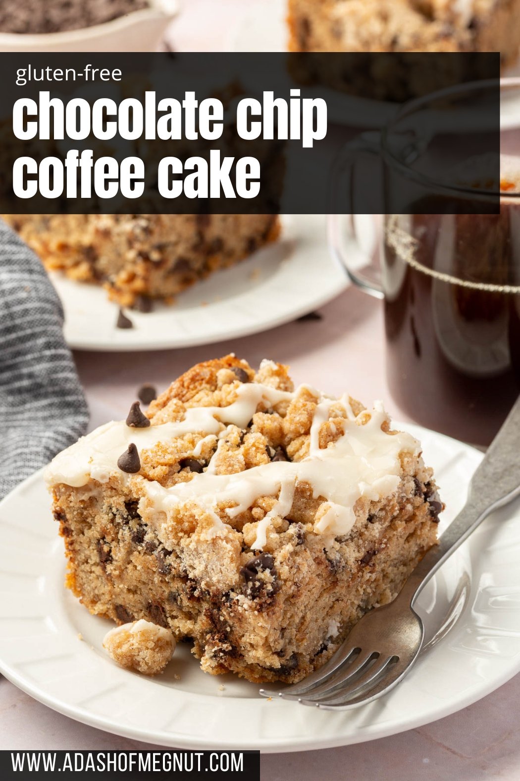 A slice of gluten free coffee cake with chocolate chips on a dessert plate with a cup of coffee and additional slices of gluten free coffee cake in the background.