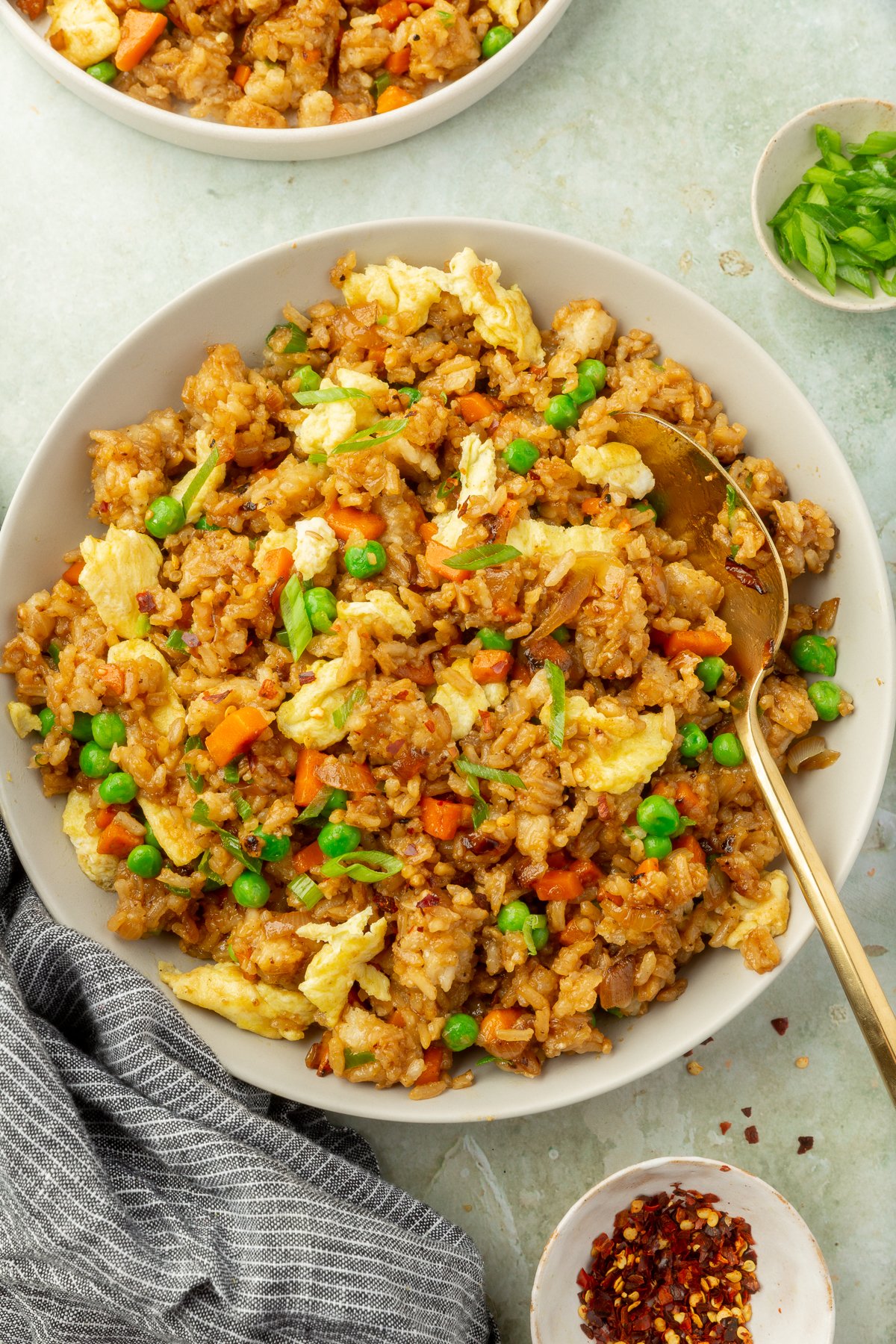 Image of white bowl with gluten-free fried rice on marble countertop.