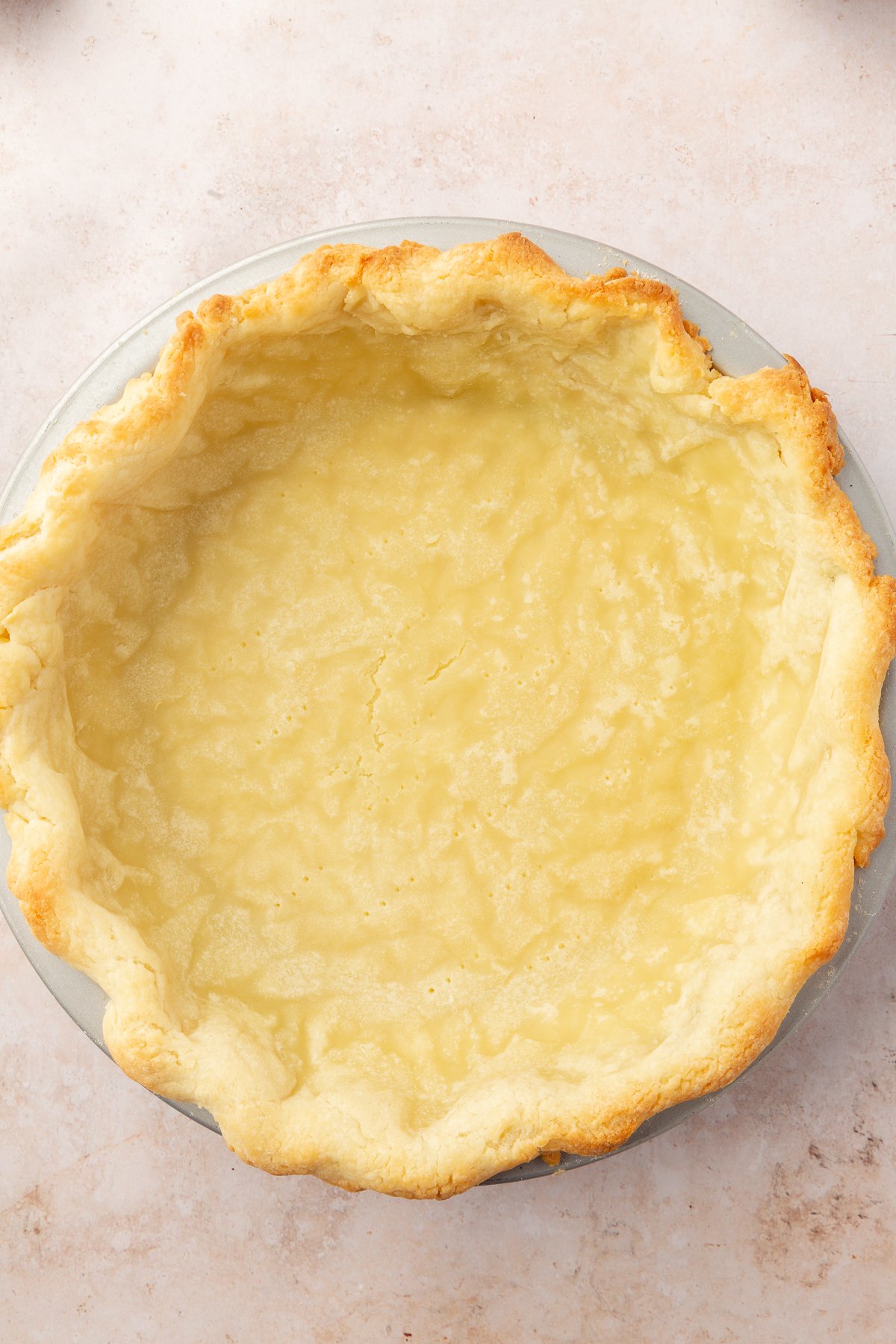Image of gluten-free pie crust in a pie dish.