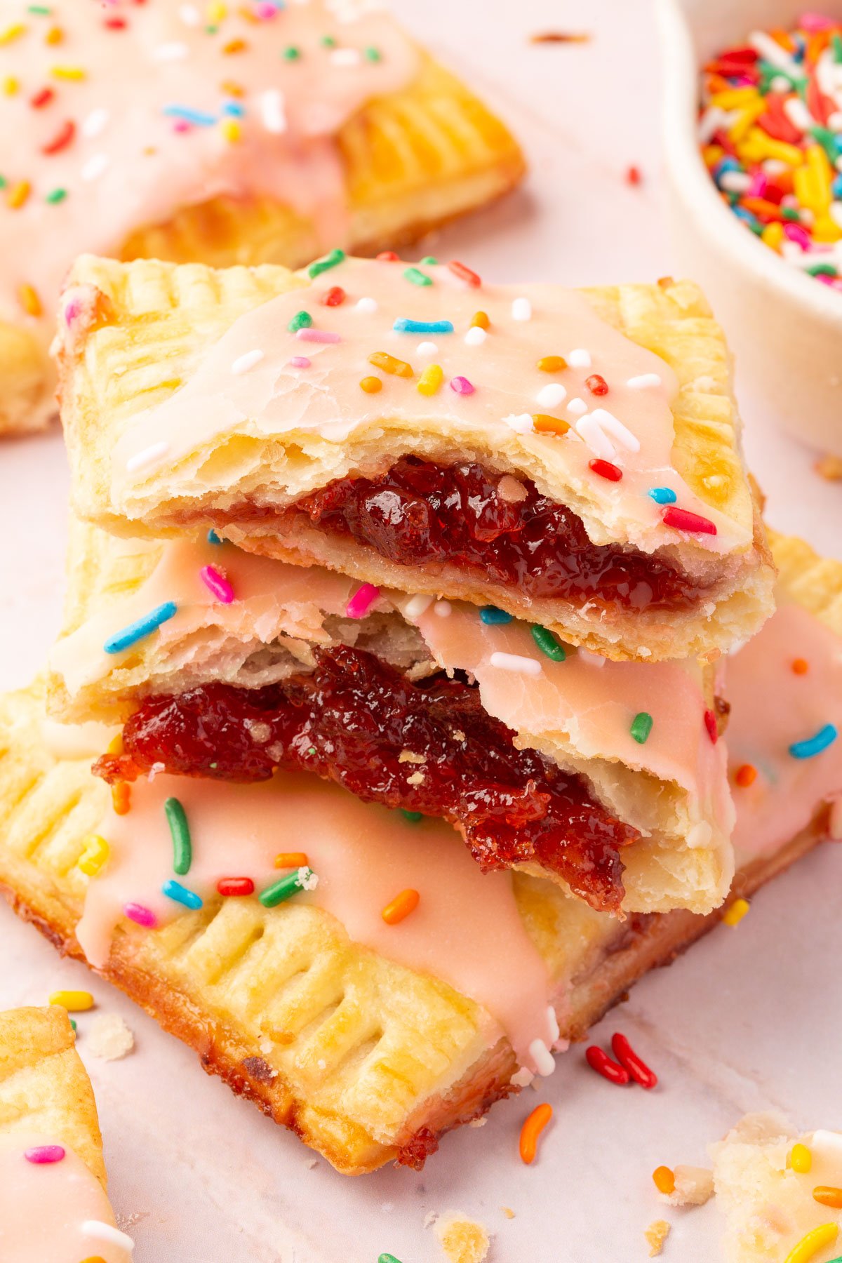 Close up image of gluten-free pop tarts broken in half, with the filling clearly shown.