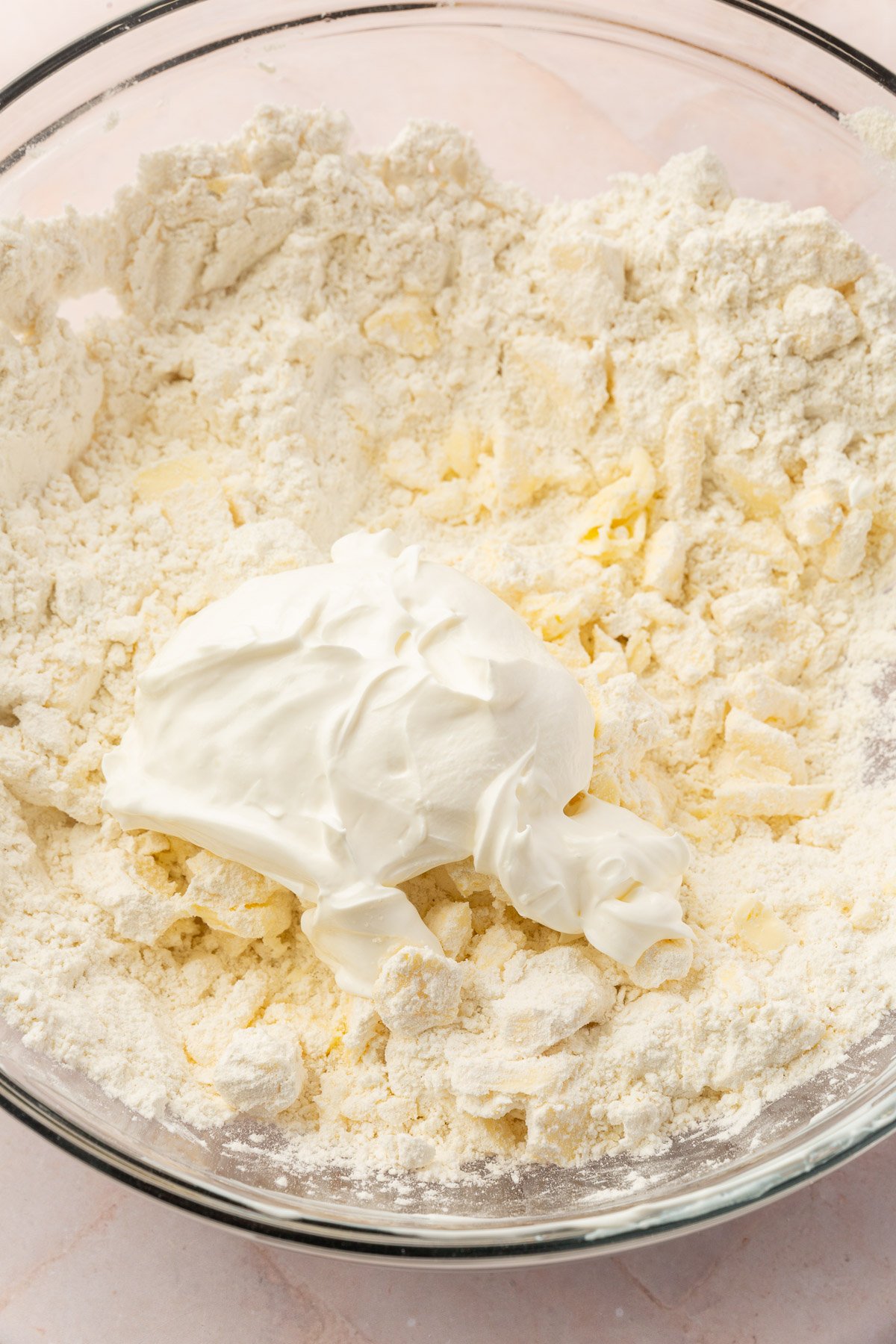 Ingredients of pop tart dough not fully mixed with sour cream on top.