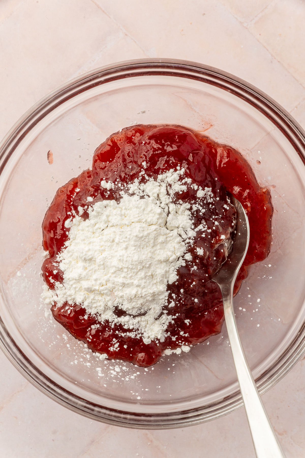 Image of mixing bowl with pop tart filling and cornstarch in the bowl with a spoon in it.