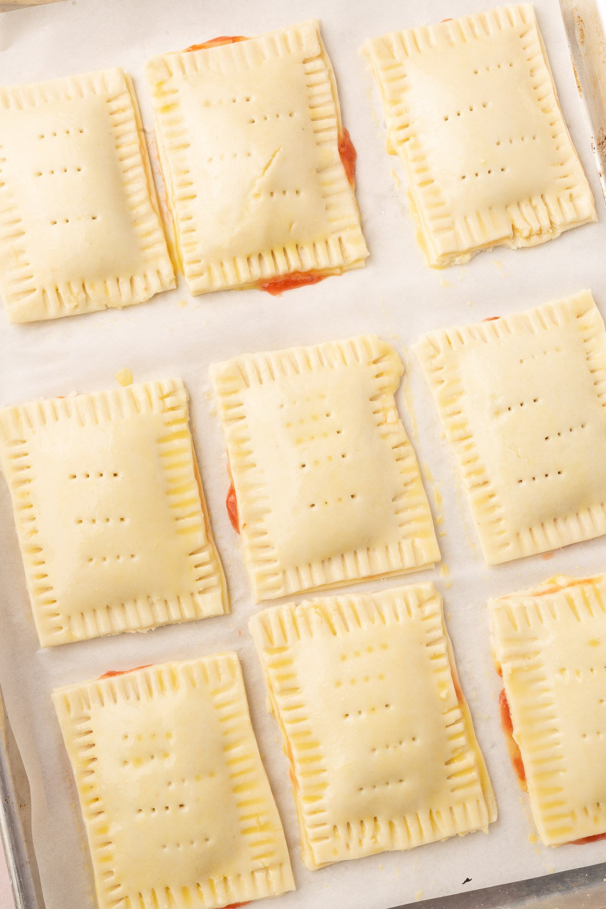 Image of uncooked pop tarts laying on baking sheet.