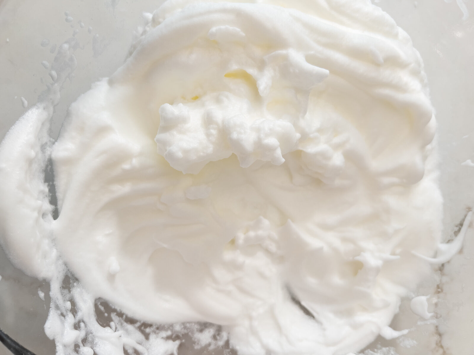 Close-up of stiffly whipped egg whites with peaks holding their shape.
