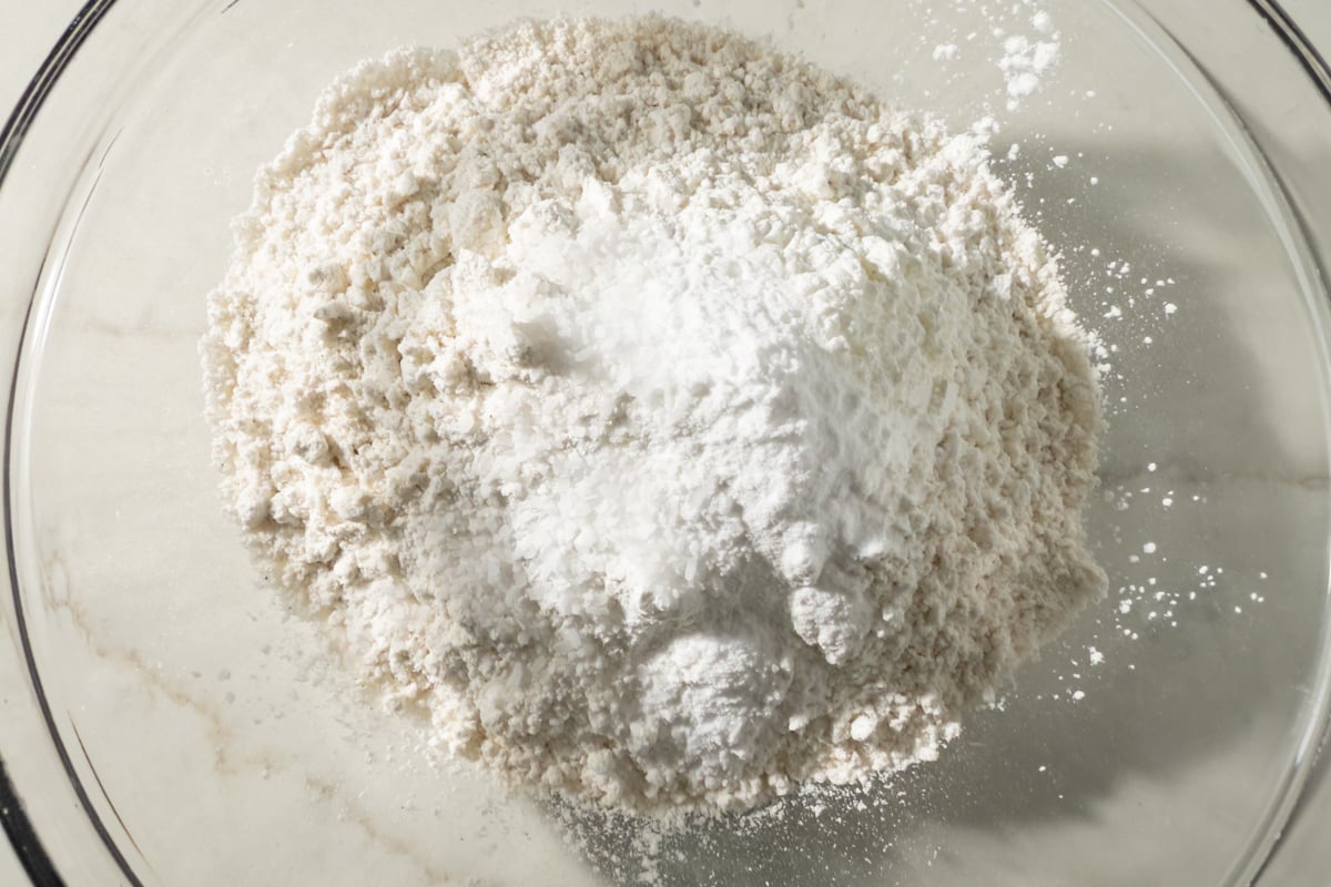 Bowl of gluten-free flour, baking soda, salt, and cornstarch ready to be whisked together.