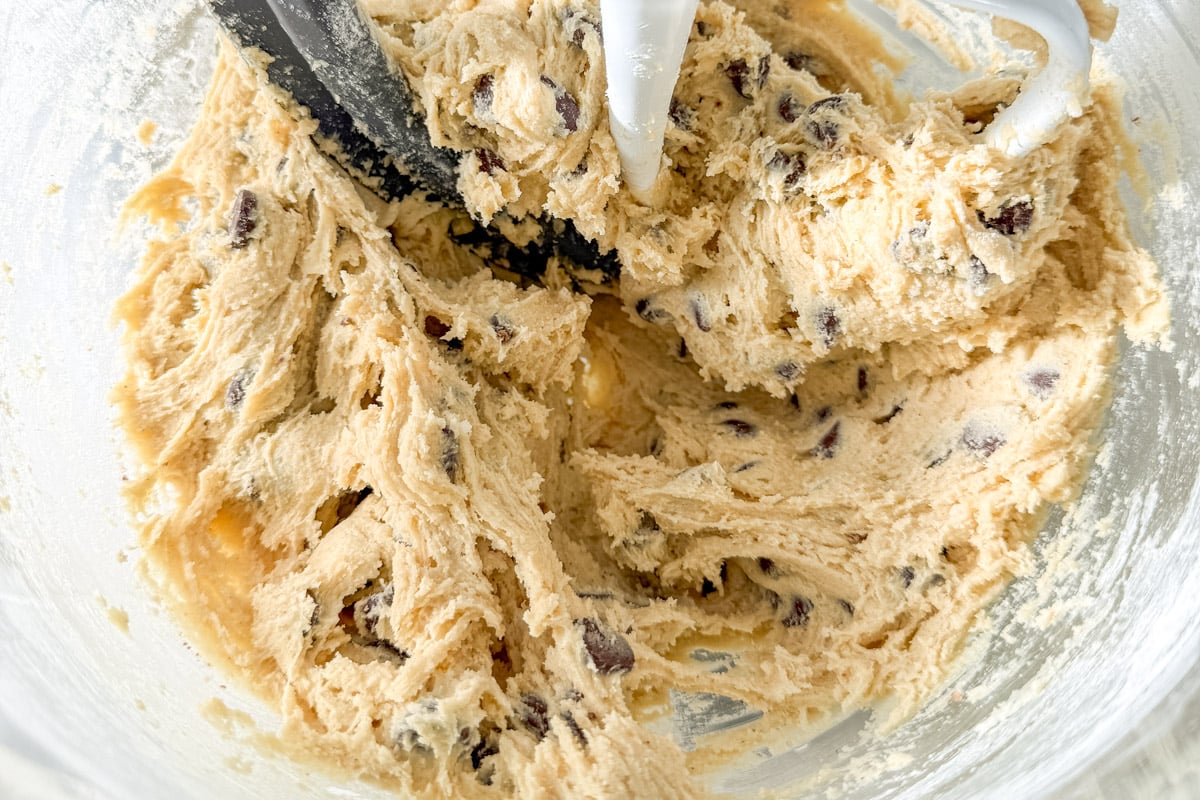 Fully mixed gluten-free chocolate chip cookie dough in a bowl, ready to be baked.