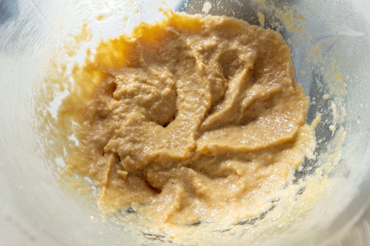 Wet ingredients combined in a mixing bowl before adding dry ingredients to form cookie dough.