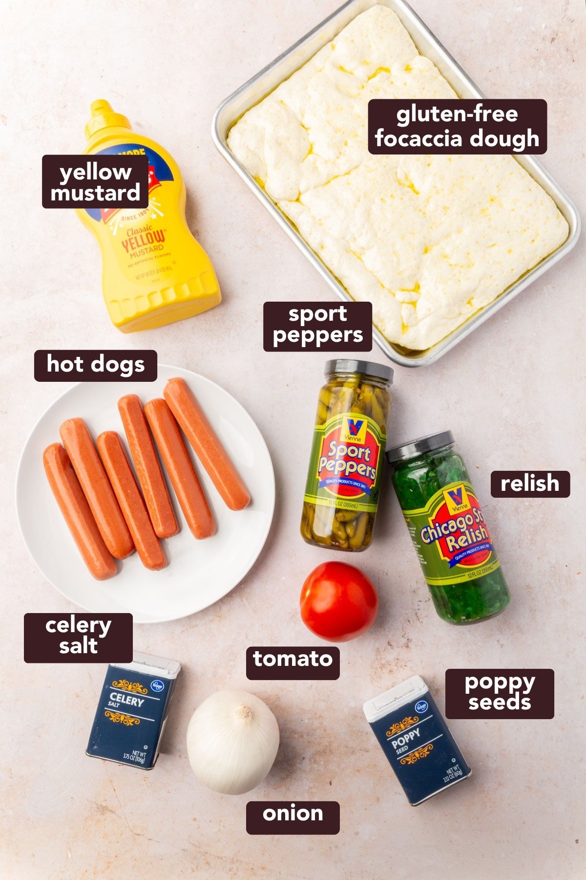 Flat lay of ingredients for gluten-free Chicago hot dog focaccia, including hot dogs, pickles, relish, and dough.