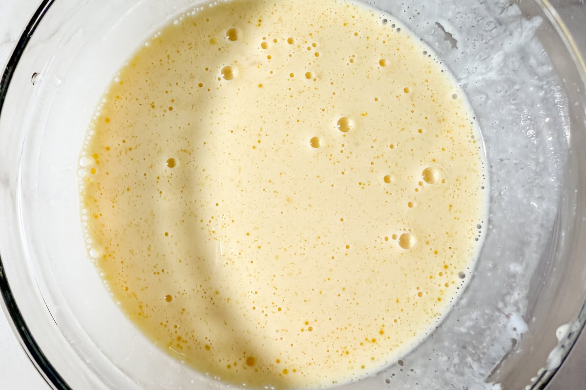 Whisked egg, milk, and oil mixture for gluten-free corn dog batter.