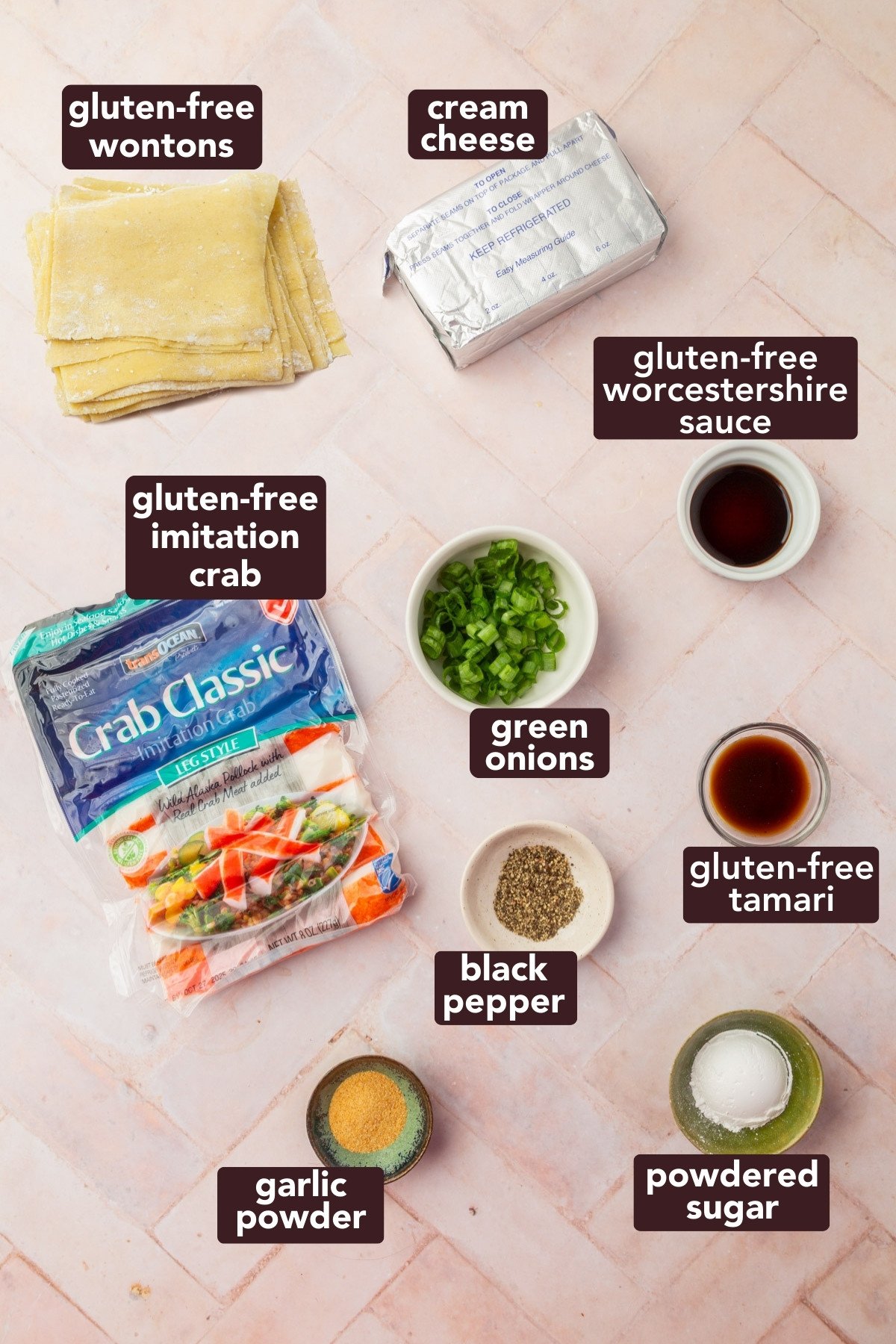 Overhead view of ingredients for gluten-free crab rangoons including wonton wrappers, imitation crab, cream cheese, and seasonings.