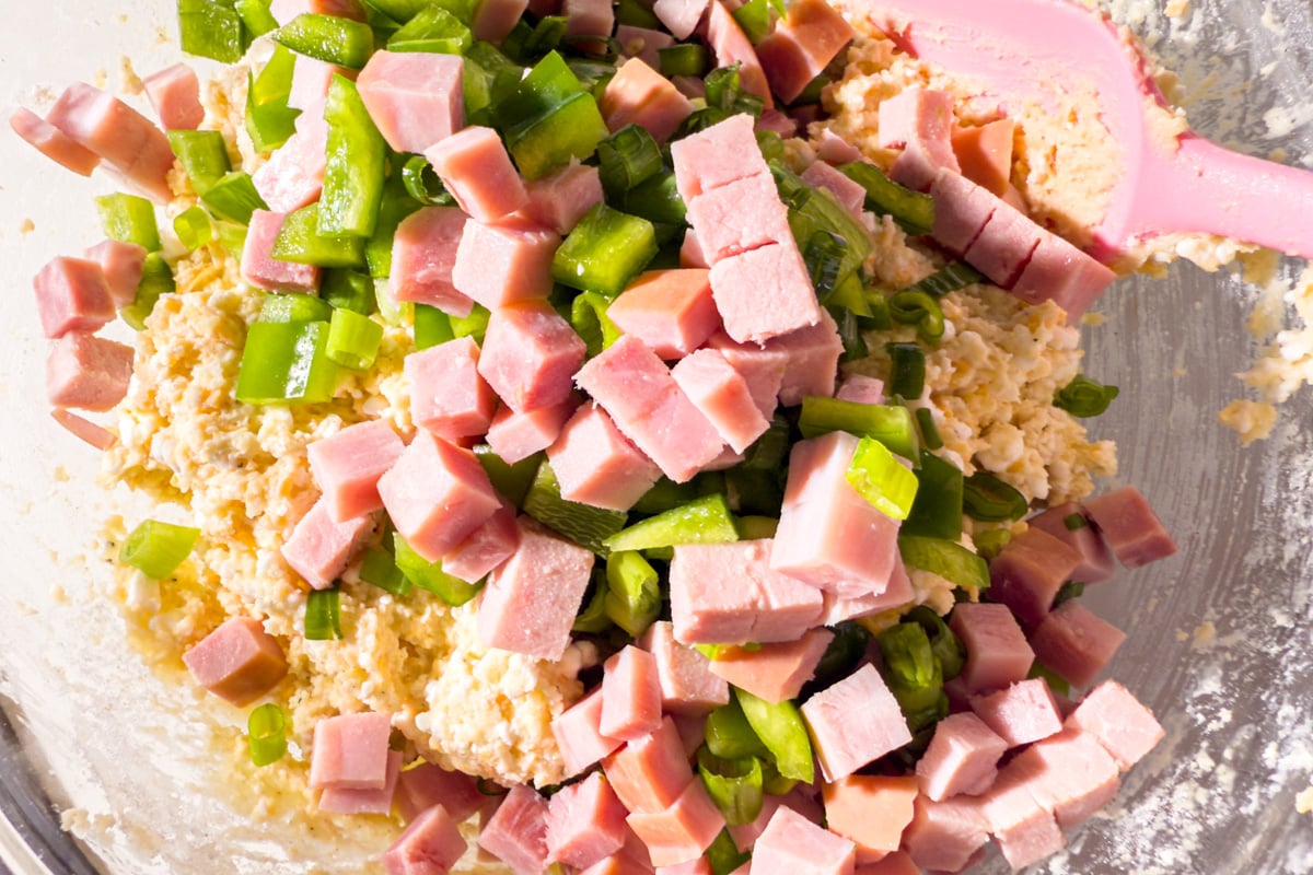 Cubes of ham and chopped green bell pepper added on top of the biscuit dough before mixing.