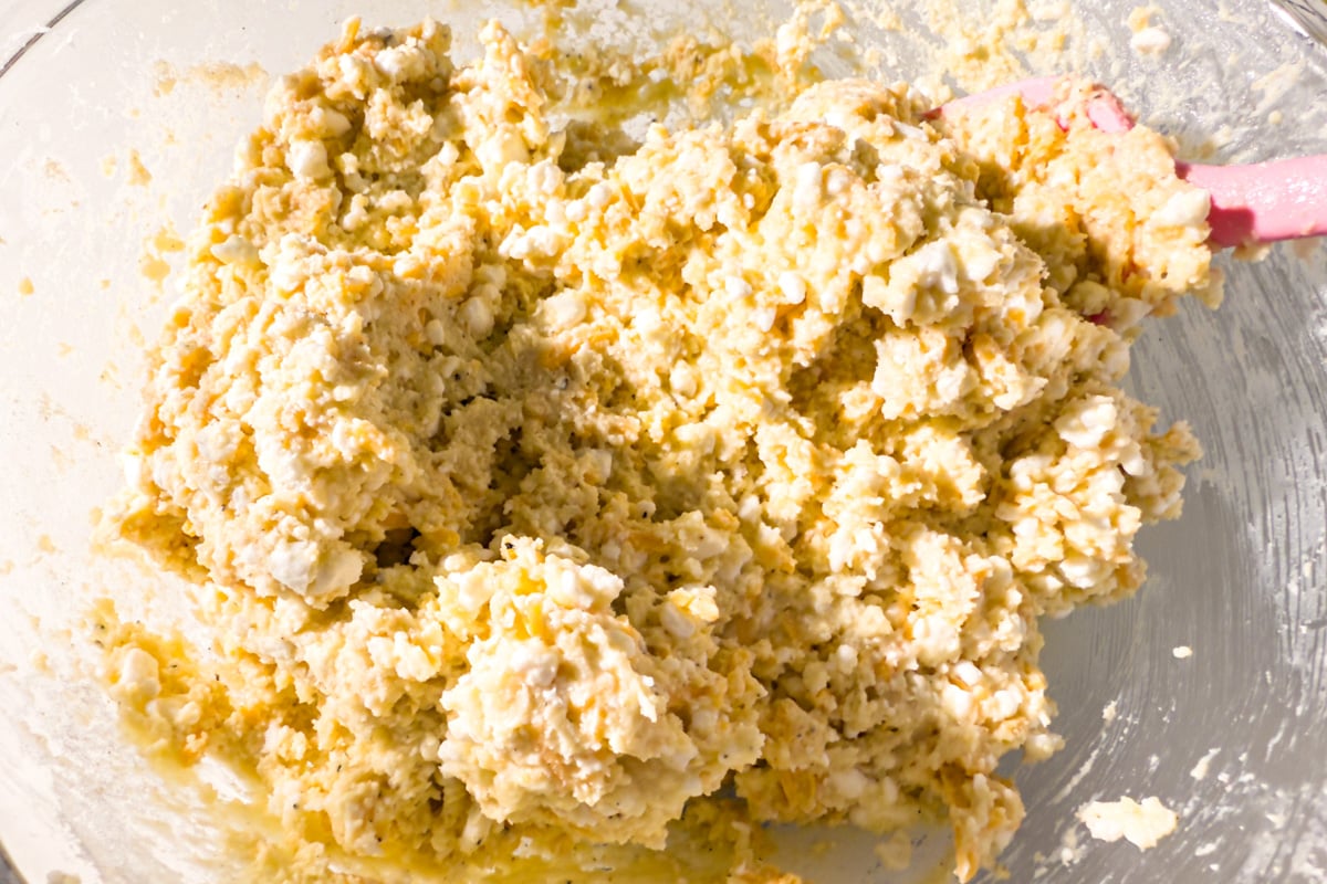 Biscuit dough mixed together with cottage cheese visible throughout the thick batter.