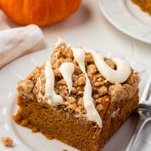 Detailed close-up of the moist crumb texture of gluten-free pumpkin coffee cake topped with streusel and glaze.