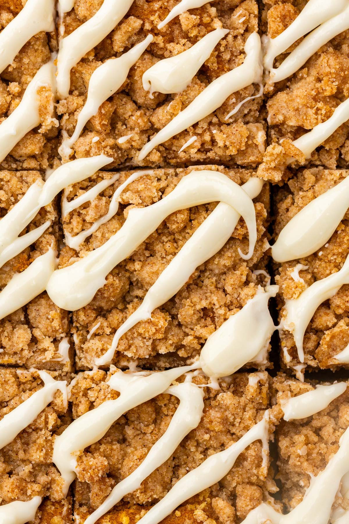 Baked gluten-free pumpkin coffee cake in a pan topped with golden brown cinnamon streusel crumbs.