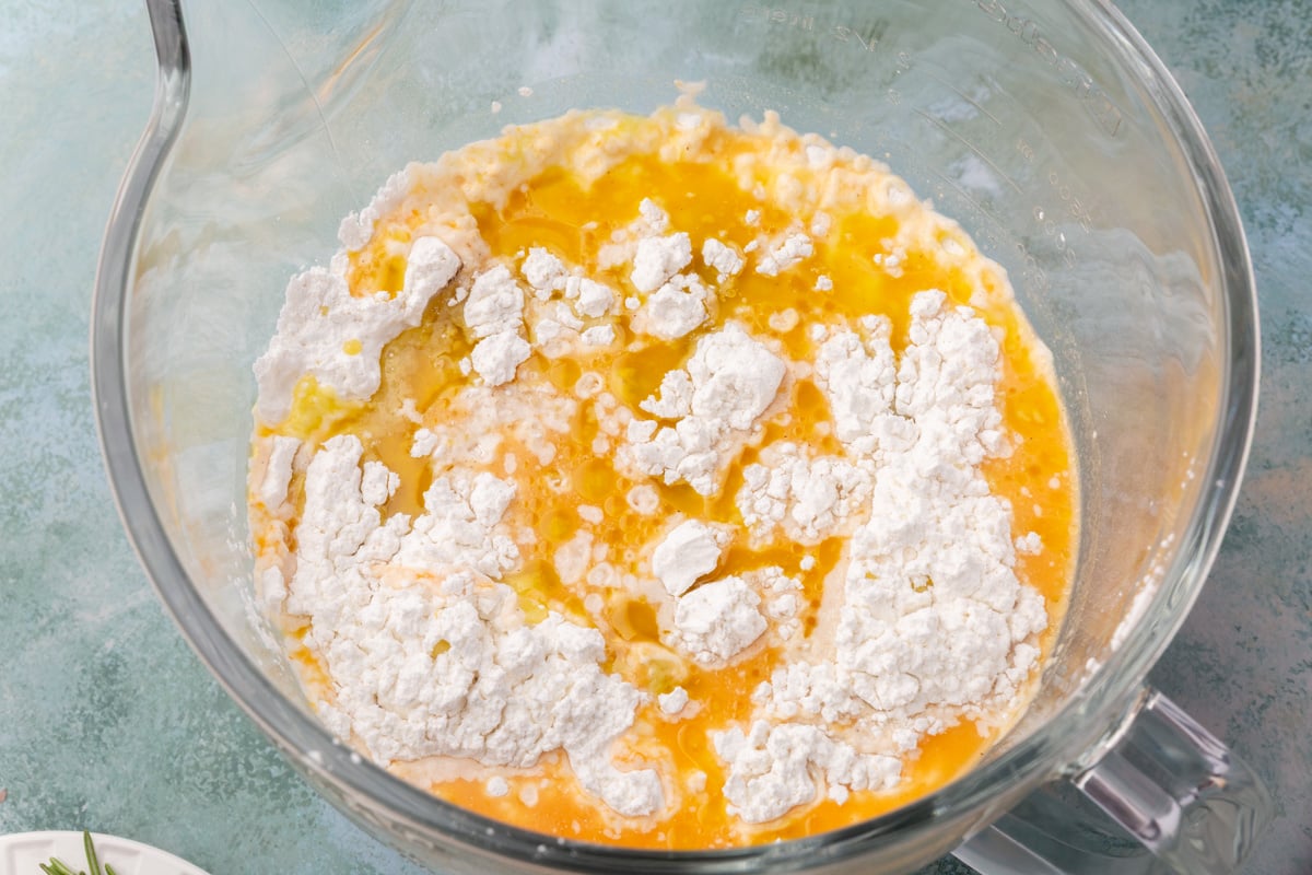 Mixing bowl with pumpkin puree, water, olive oil, and gluten-free flour for pumpkin focaccia.