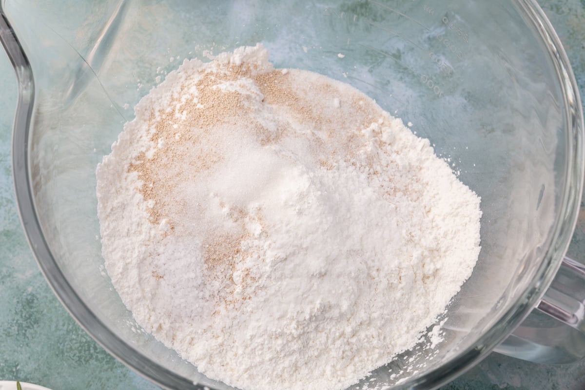 Dry ingredients in a mixing bowl — gluten-free flour, yeast, sugar, and salt for pumpkin focaccia.