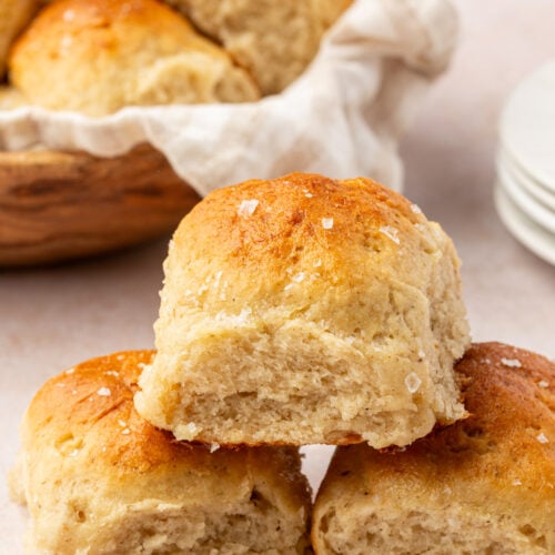 Stack of soft gluten-free dinner rolls showing the fluffy interior texture.