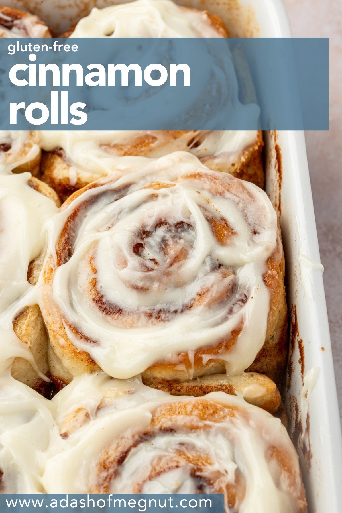 Frosted gluten-free cinnamon roll on a plate with a text overlay reading “gluten-free cinnamon rolls.”