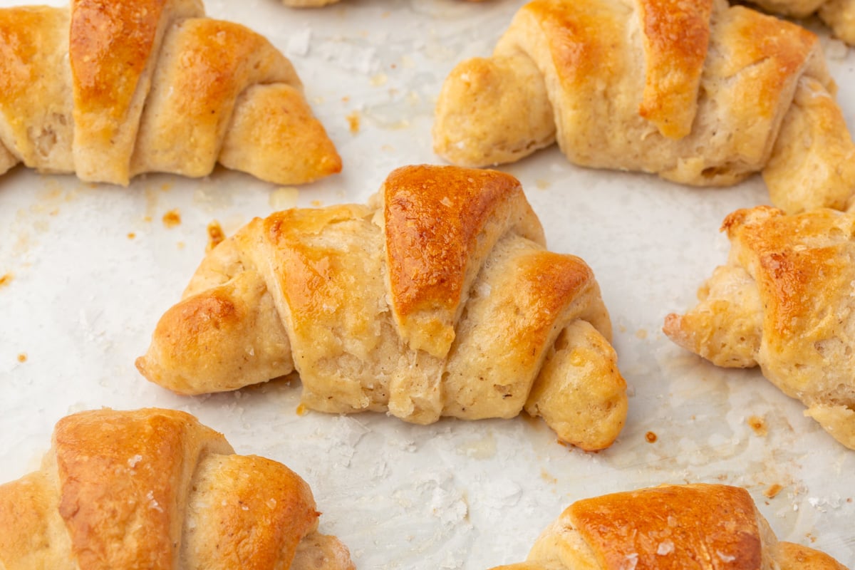 Gluten-free crescent rolls arranged on baking sheet before baking.