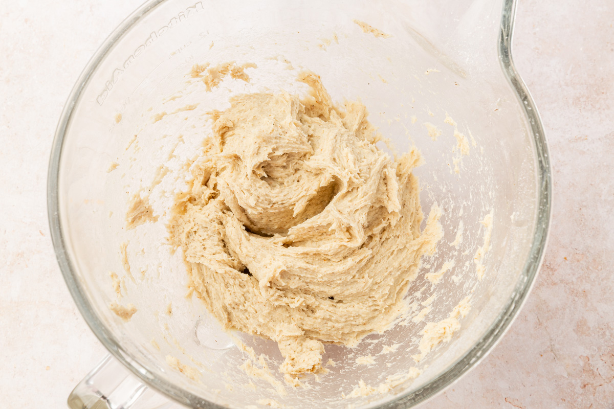 Soft, sticky gluten-free dough after mixing in a stand mixer bowl.