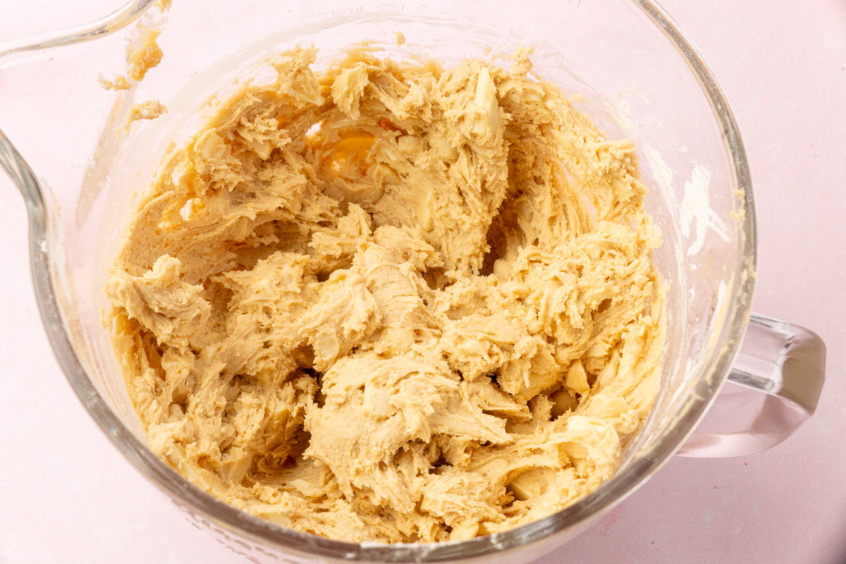 Cookie dough with white chocolate and macadamia nuts fully mixed in.