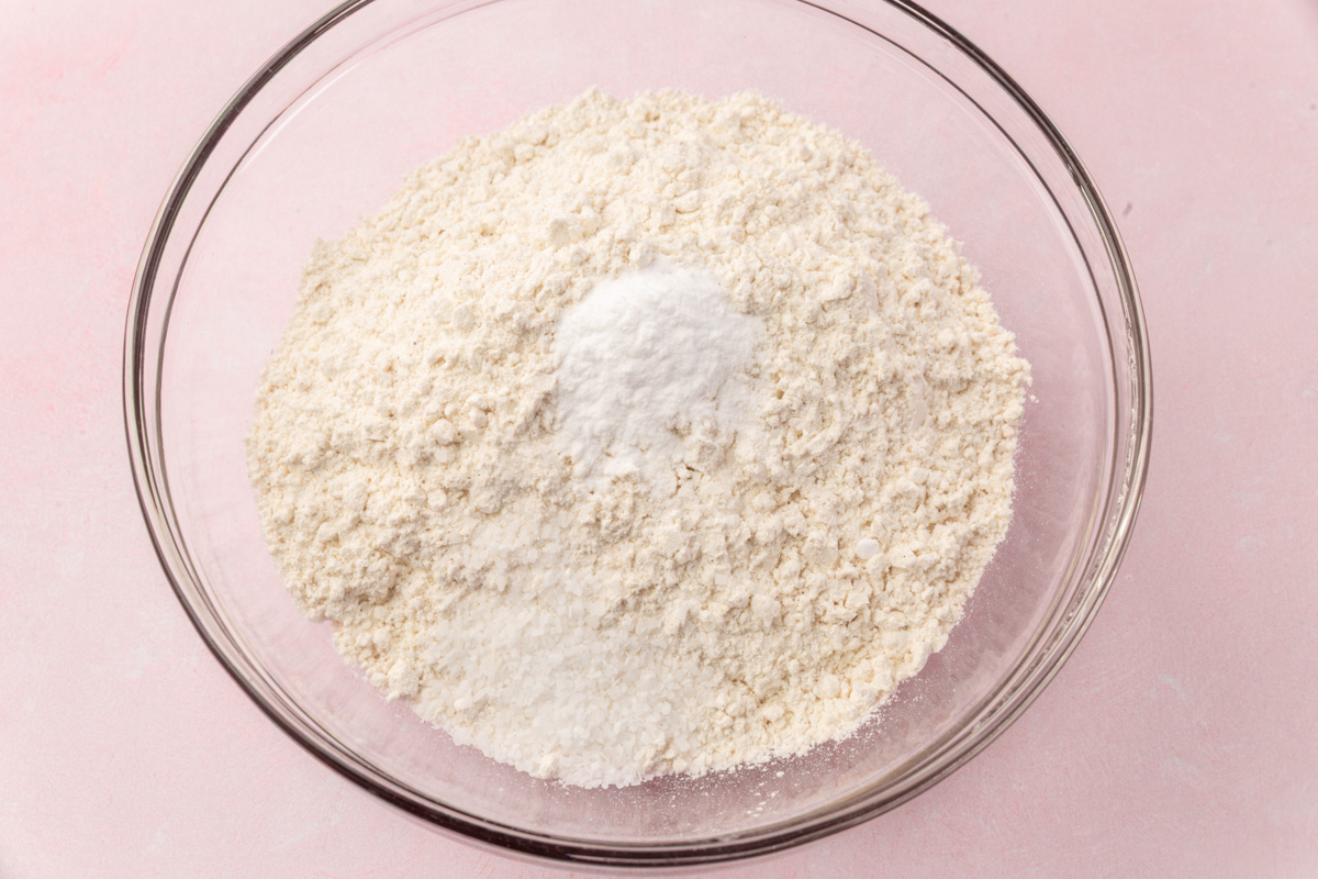 Gluten-free flour mixture with baking soda and salt in a glass bowl.