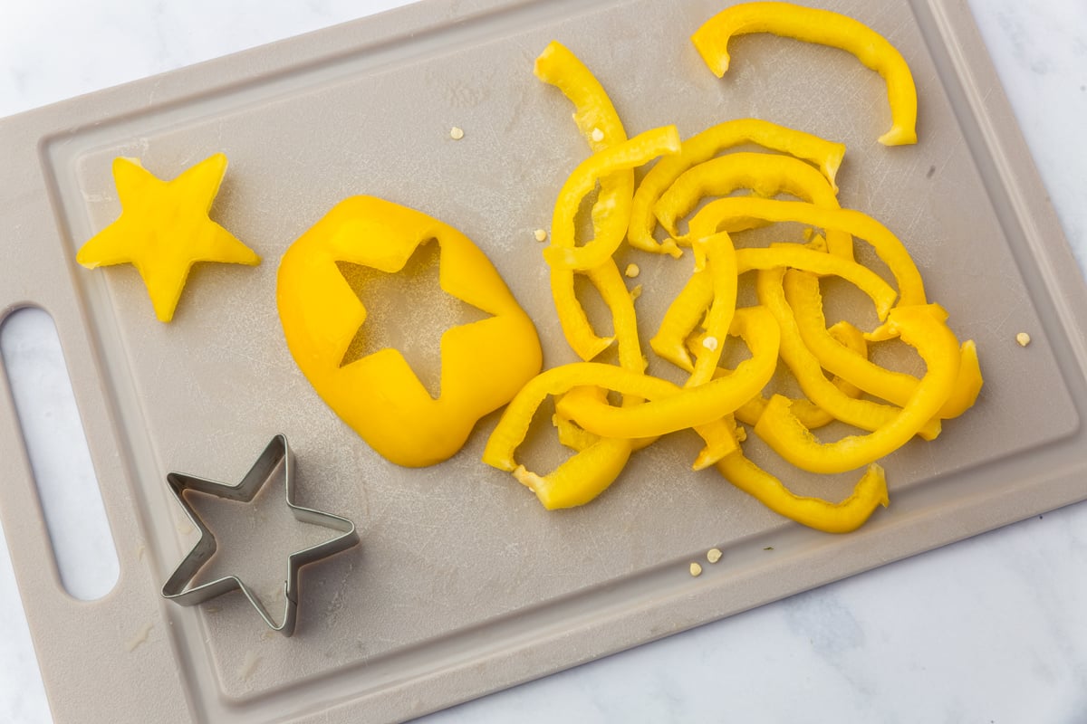 ellow bell pepper star and curved garland strips cut along natural ridges for Christmas tree focaccia decorations.
