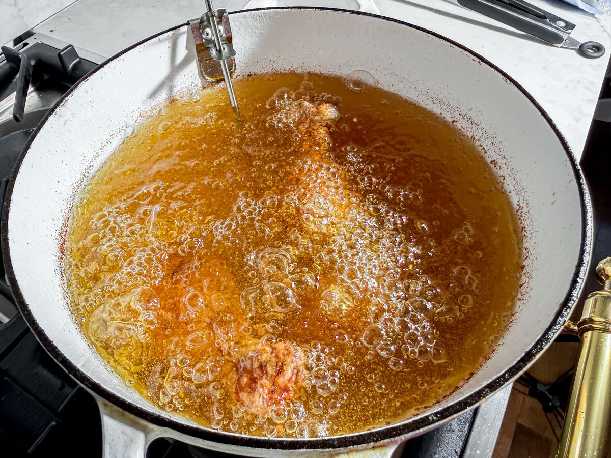 Oil heated to 325°F in a large pot for frying gluten-free chicken.