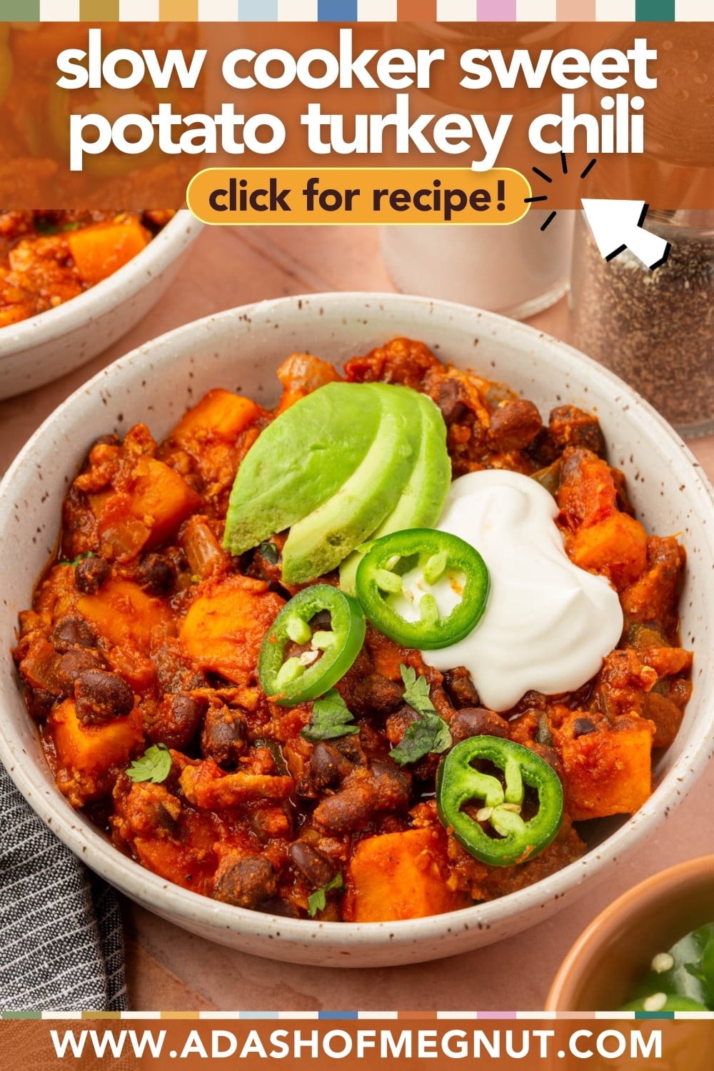 A bowl of sweet potato turkey chili topped with avocado slices, jalapeño, and sour cream, with text overlay: slow cooker sweet potato turkey chili, click for recipe! and website www.adashofmegnut.com.