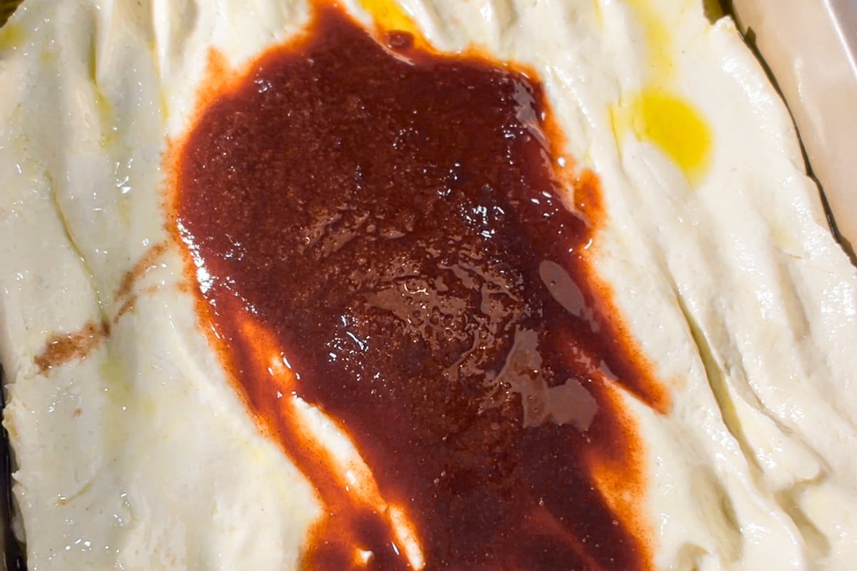 Melted cinnamon roll filling added to the top of gluten-free focaccia dough.