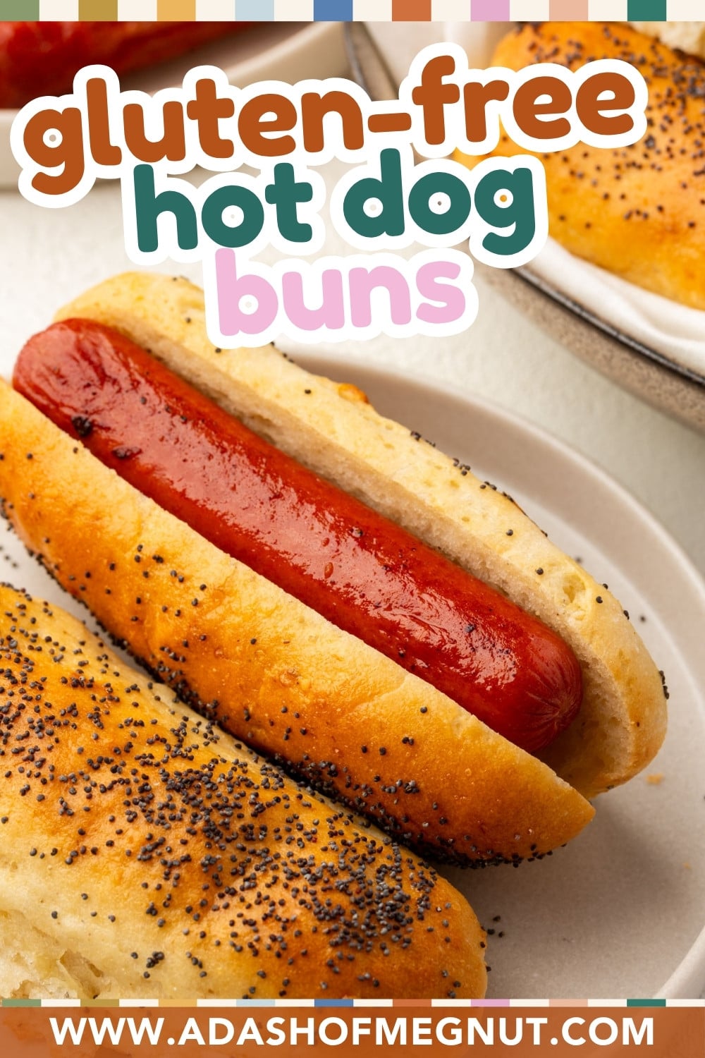 Two hot dogs in gluten-free poppy seed buns are shown on a white plate. Text above reads gluten-free hot dog buns. The website www.adashofmegnut.com appears at the bottom.