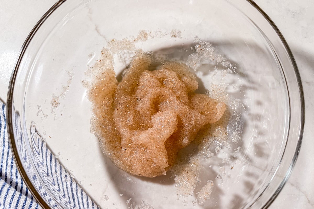 A textured, light brown psyllium gel mixture in a glass mixing bowl.