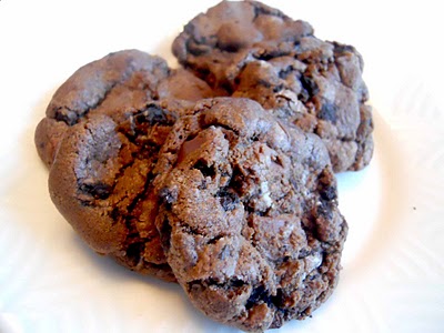 A pile of gluten-free chocolate oreo chunk cookies on a white plate.