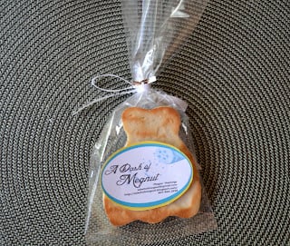 A wedding dress sugar cookie in a treat bag tied with a bow.